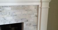 Fireplace mantle and surround - hand cut, custom pattern tile (Calcutta gold marble)