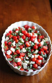 1 cups Balsamic Vinegar 2 packages of grape tomatoes (sliced each in half) 12 ounces Mozzarella Cheese balls (diced into pieces) Fresh Basil Leaves (shredded) 1/4 cup Olive Oil Kosher Salt And Freshly Ground Black Pepper