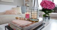 Love the muted colors. Stacked books with two candles on top and a flower arrangement in a galvenized bucket.